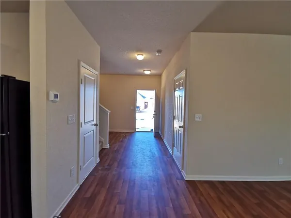 a view of hallway with wooden floor