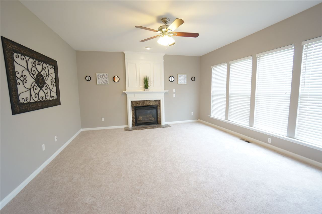 7730 San Gabriel Street Raleigh, NC 27613 - Photo 11 of 25 Living room is showered by soft, beautiful natural lighting. Fireplace is an attractive focal piece that grounds the space nicely. Living Room