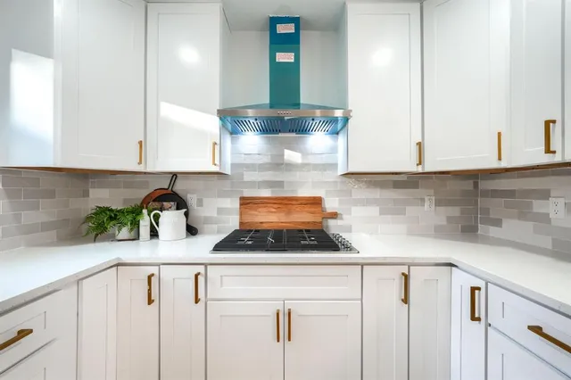 a kitchen with a stove and cabinets