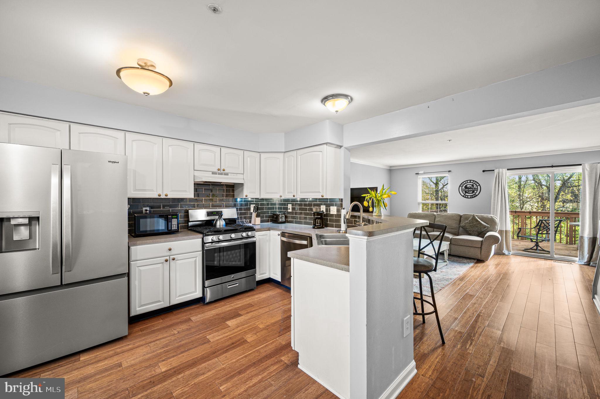 588 Coach Hill Court West Chester, PA 19380 - Photo 2 of 18 a kitchen with white cabinets and stainless steel appliances