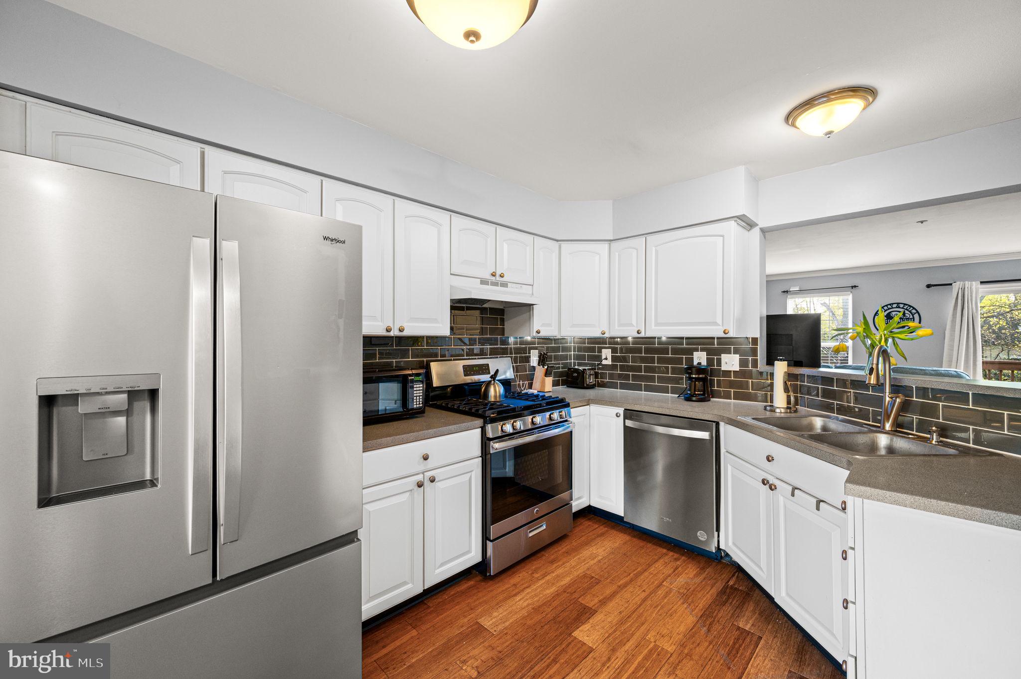 588 Coach Hill Court West Chester, PA 19380 - Photo 3 of 18 a kitchen with white cabinets and white appliances