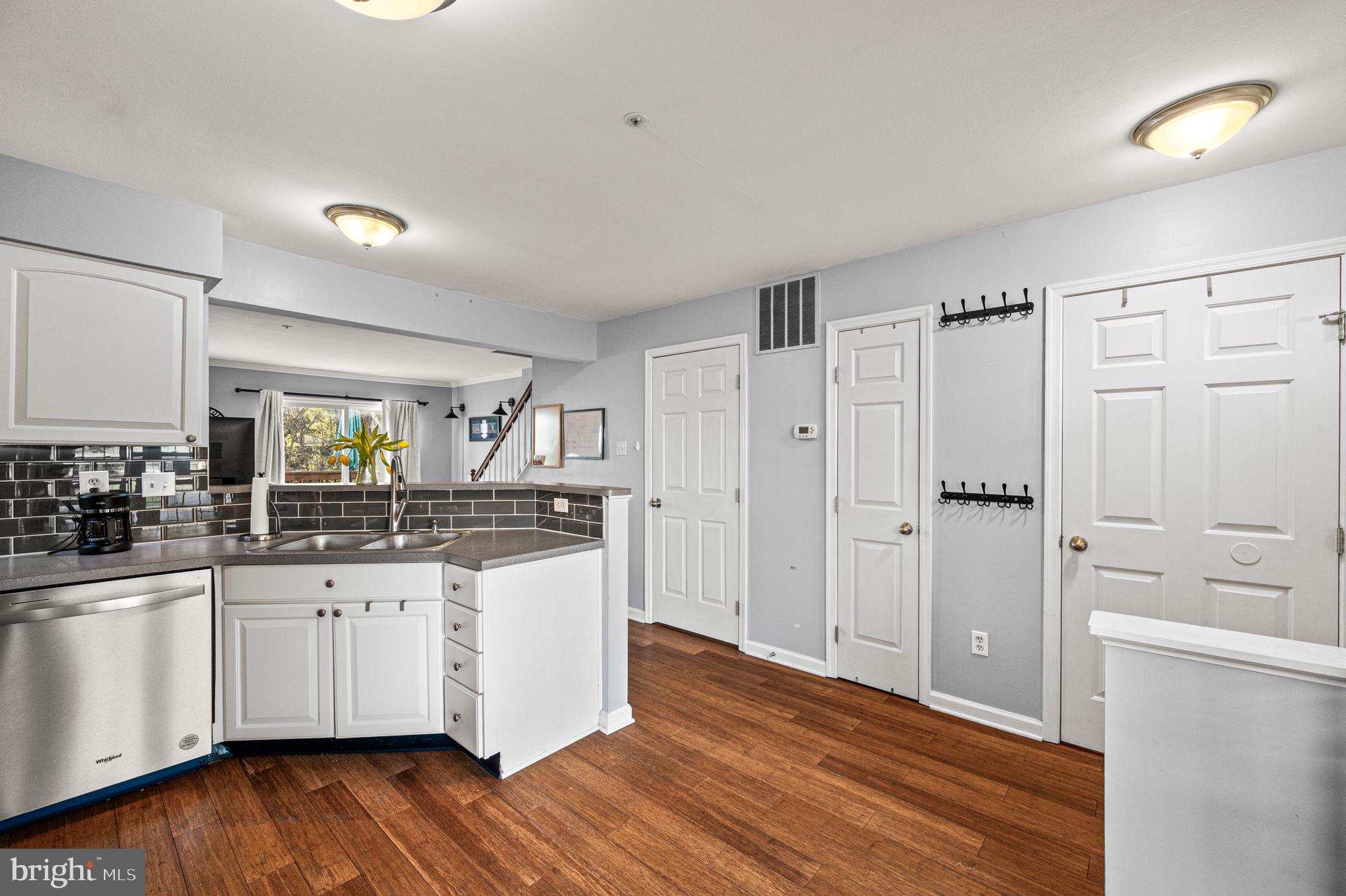 588 Coach Hill Court West Chester, PA 19380 - Photo 4 of 18 a kitchen with granite countertop a sink and cabinets with wooden floors