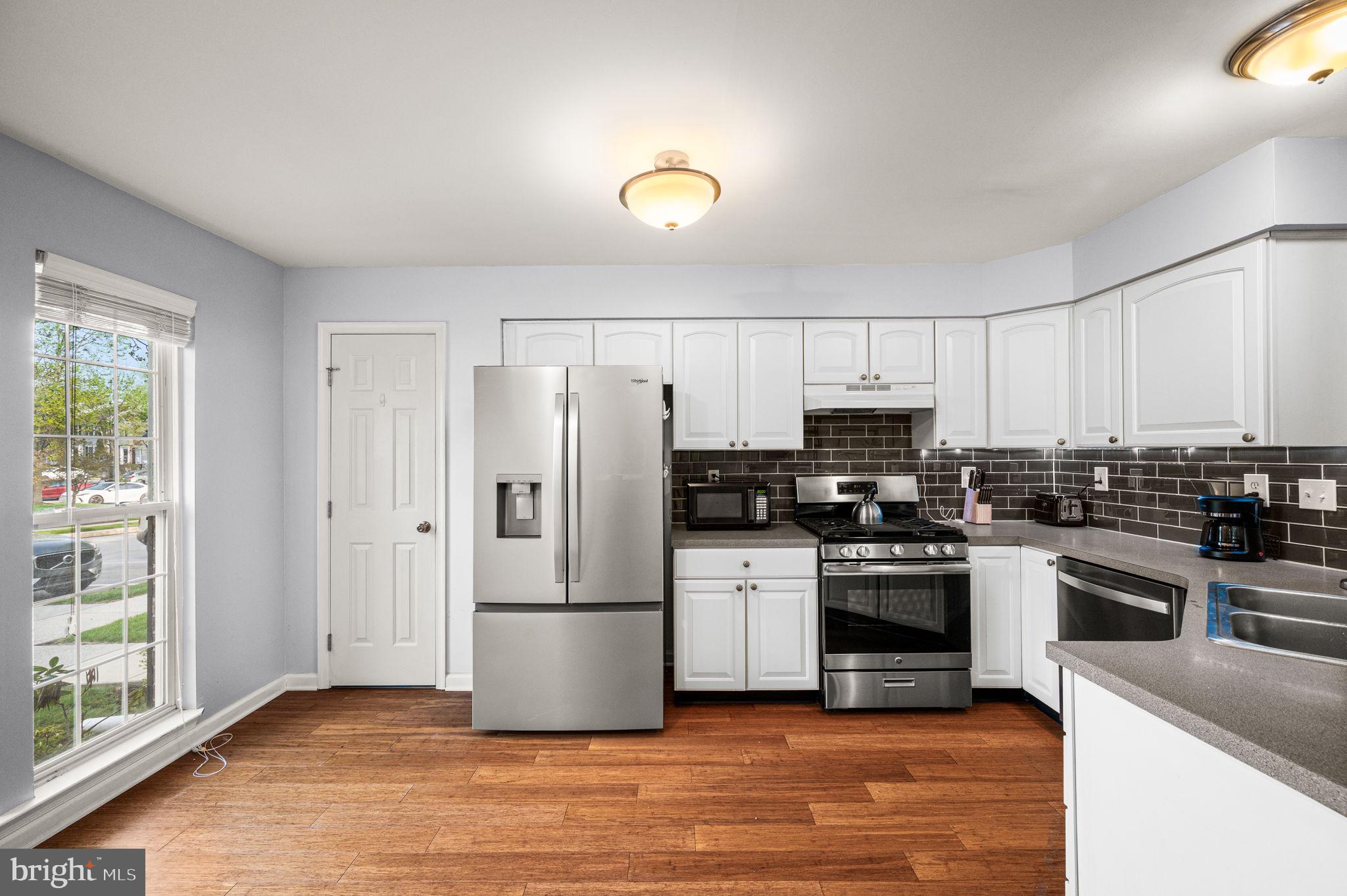 588 Coach Hill Court West Chester, PA 19380 - Photo 5 of 18 a kitchen with granite countertop a refrigerator stove and sink