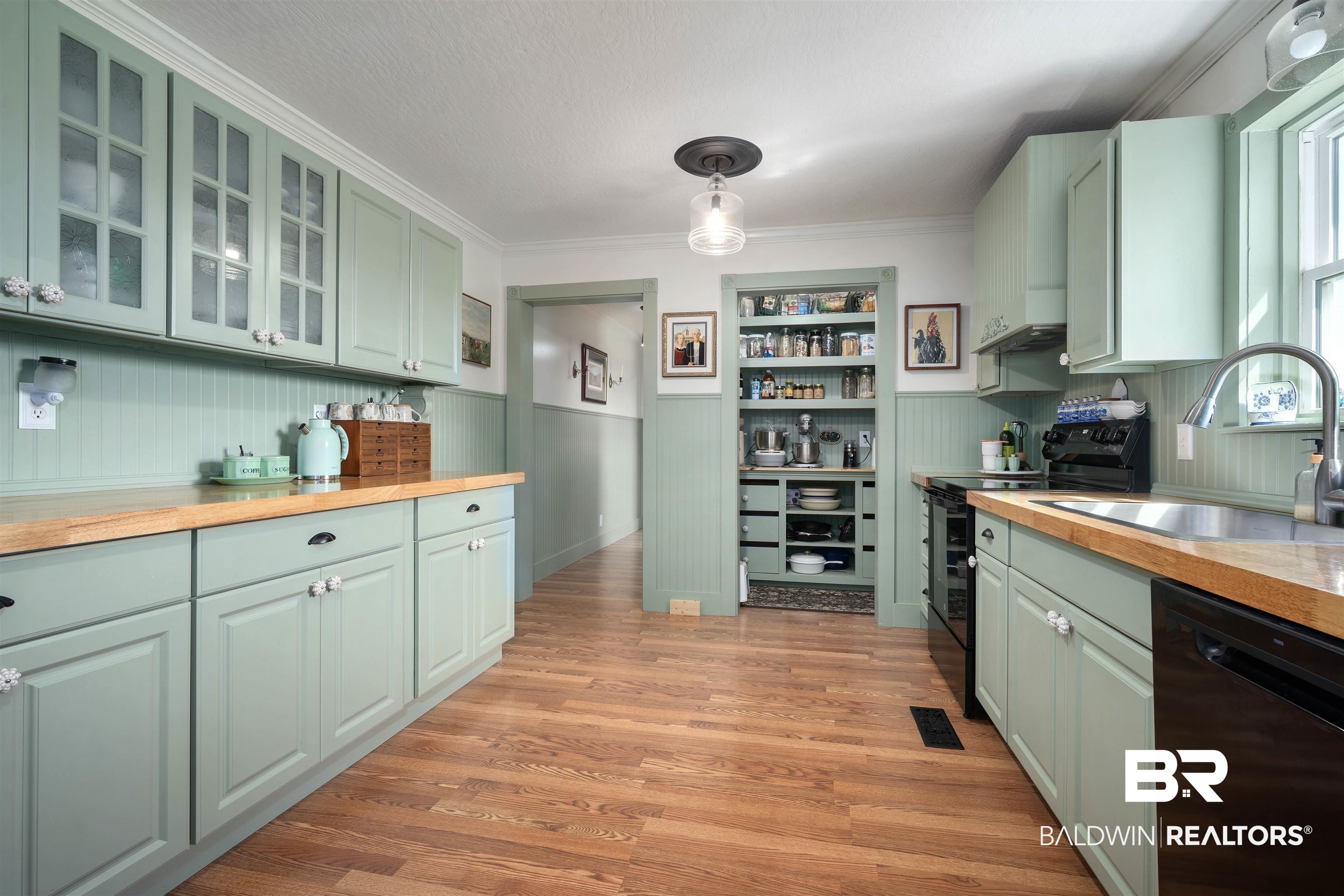 22 Horace Odom Road Millry, AL 36558 - Photo 11 of 39 Kitchen with black appliances, wood counters, green cabinetry, light wood-style floors, and hanging light fixtures
