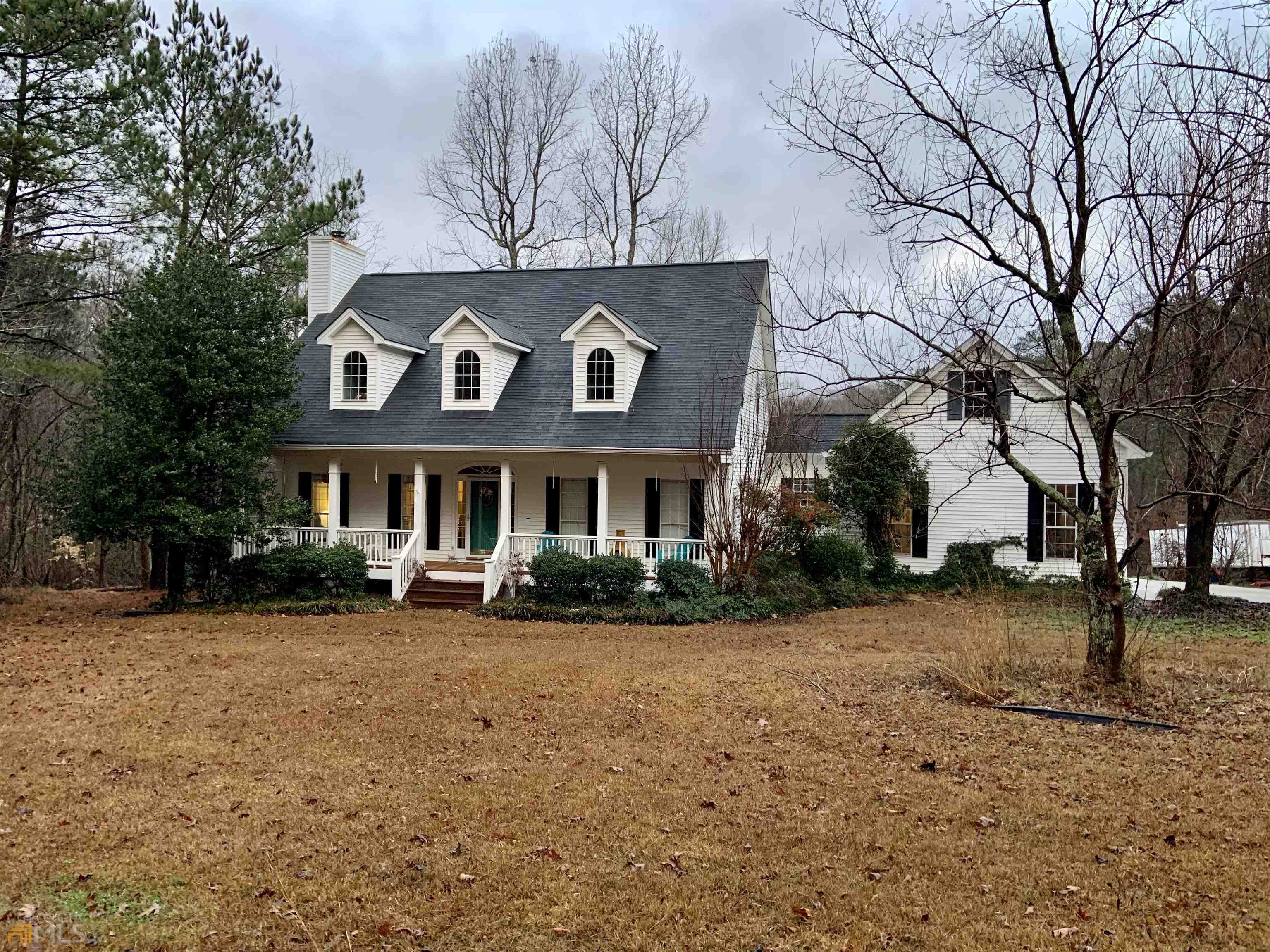 1483 4 Notch Road Carrollton, GA 30116 - Photo 1 of 1 a front view of a building with large trees