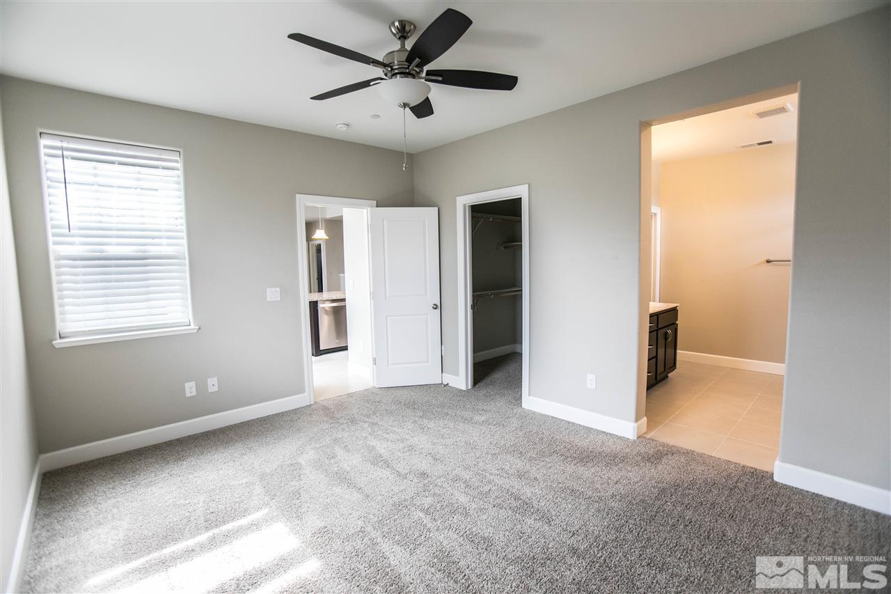 1856 Sea Horse Road, Unit A Reno, NV 89521 - Photo 12 of 16 a view of a big room with windows and a ceiling fan