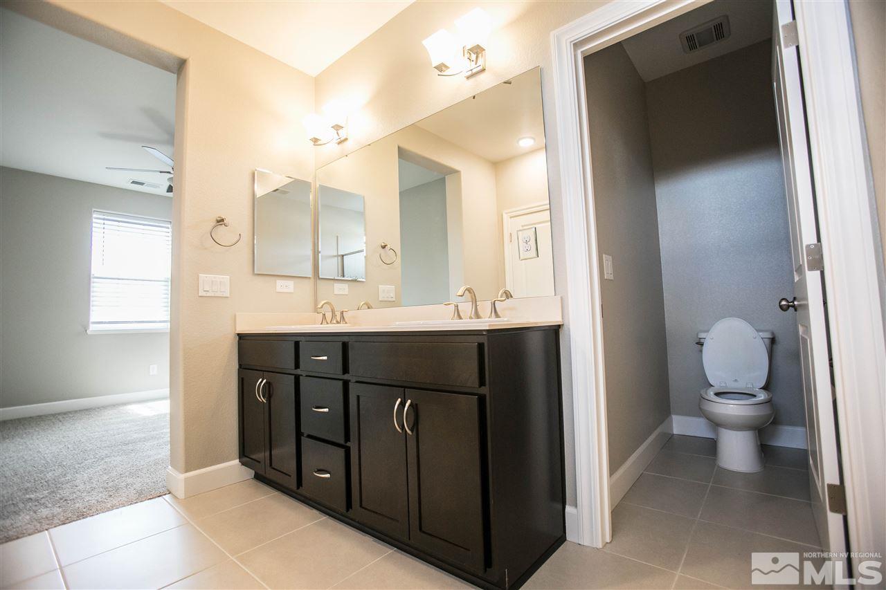 1856 Sea Horse Road, Unit A Reno, NV 89521 - Photo 15 of 16 a bathroom with a sink vanity and a toilet
