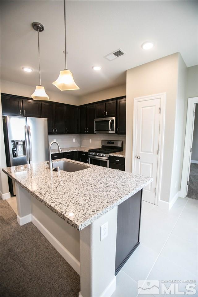1856 Sea Horse Road, Unit A Reno, NV 89521 - Photo 5 of 16 a kitchen with stainless steel appliances granite countertop a sink a stove a refrigerator and a oven