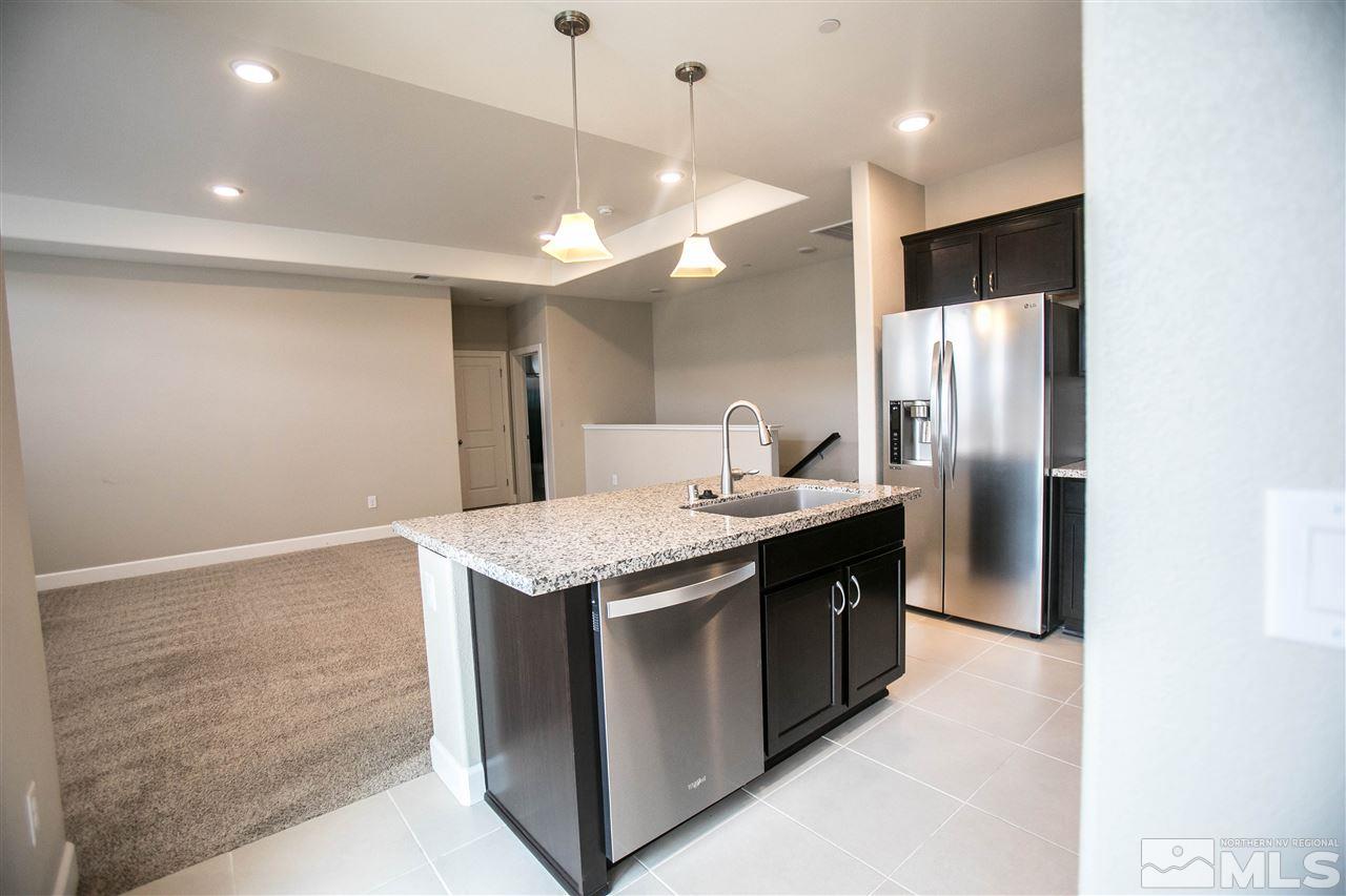1856 Sea Horse Road, Unit A Reno, NV 89521 - Photo 6 of 16 a kitchen with stainless steel appliances granite countertop a sink a refrigerator and a stove