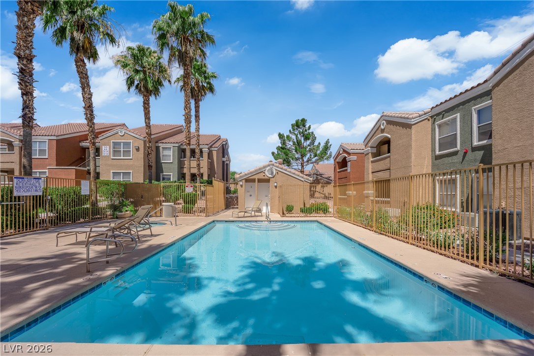8101 West Flamingo Road, Unit 2030 Las Vegas, NV 89147 - Photo 8 of 27 A pristine swimming pool offers cool refreshment amidst a sunny residential landscape.