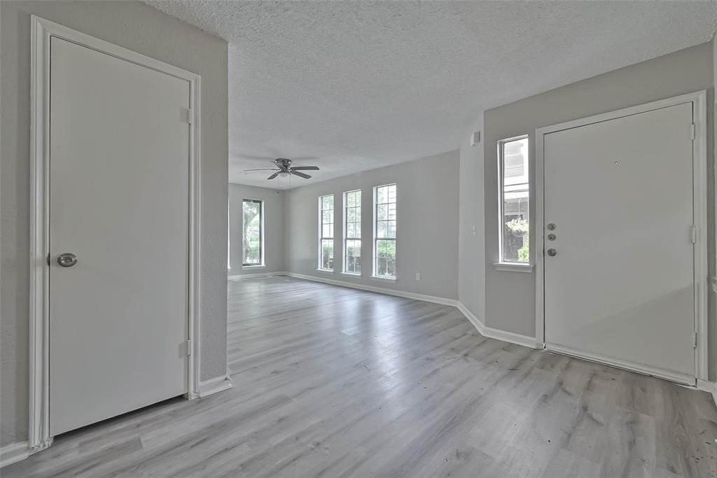 17805 Villa Way Drive Spring, TX 77379 - Photo 11 of 50 a view of an empty room with wooden floor and a window