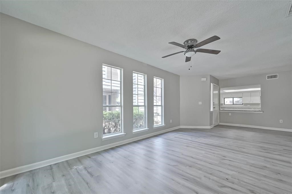 17805 Villa Way Drive Spring, TX 77379 - Photo 14 of 50 a view of an empty room with a window and wooden floor