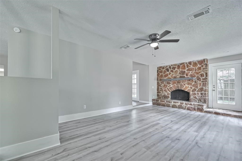 17805 Villa Way Drive Spring, TX 77379 - Photo 15 of 50 wooden floor fireplace and windows in an empty room