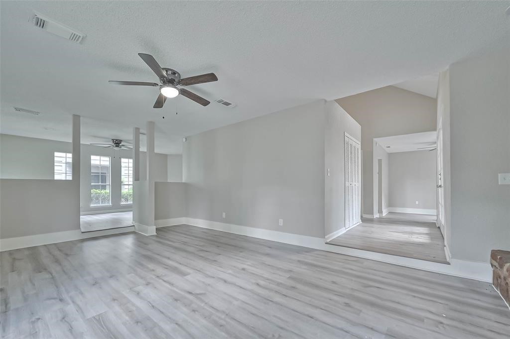 17805 Villa Way Drive Spring, TX 77379 - Photo 16 of 50 an empty room with wooden floor and windows