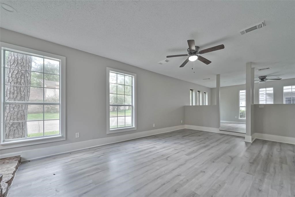 17805 Villa Way Drive Spring, TX 77379 - Photo 17 of 50 a view of an empty room with a window and wooden floor