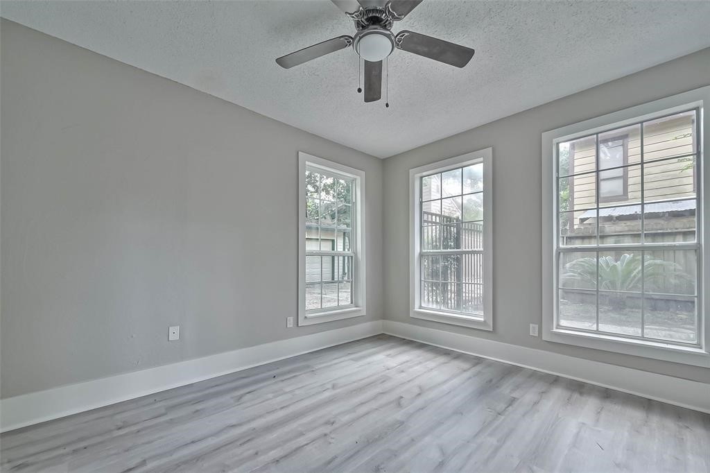 17805 Villa Way Drive Spring, TX 77379 - Photo 19 of 50 a view of an empty room with a window and wooden floor