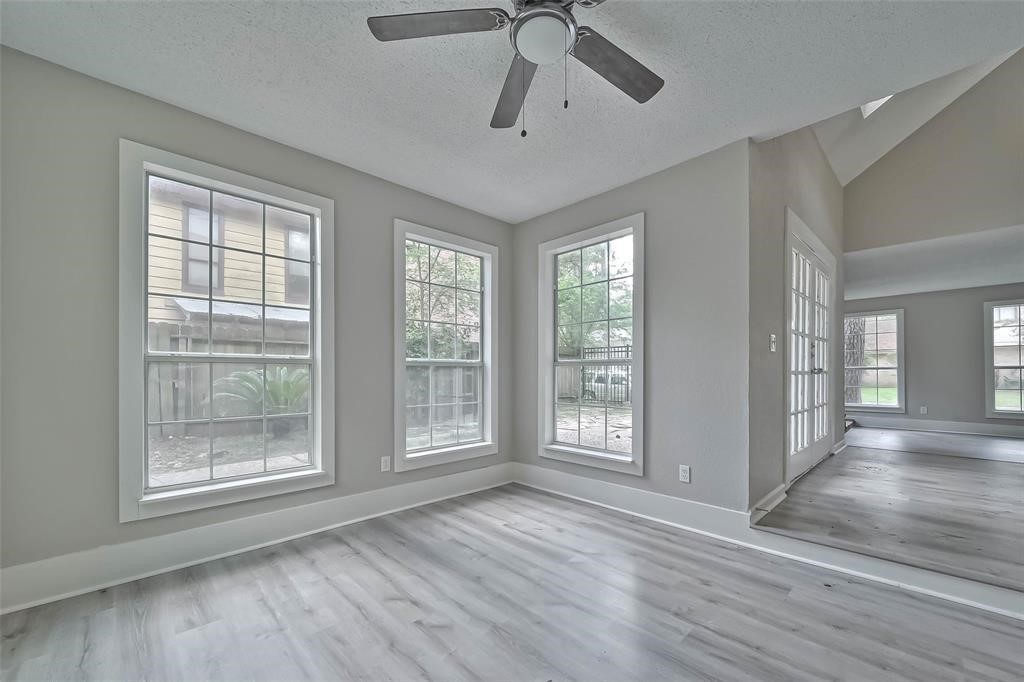 17805 Villa Way Drive Spring, TX 77379 - Photo 20 of 50 a view of an empty room with wooden floor and a window