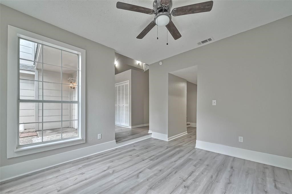 17805 Villa Way Drive Spring, TX 77379 - Photo 21 of 50 an empty room with wooden floor closet and windows