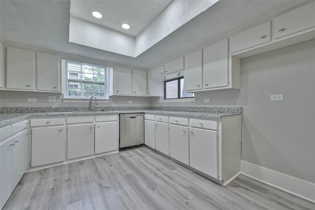 17805 Villa Way Drive Spring, TX 77379 - Photo 23 of 50 a kitchen with granite countertop white cabinets white appliances a sink and a window