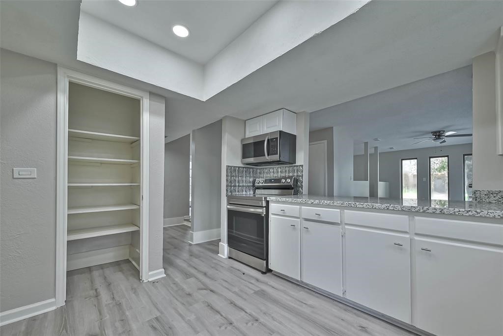 17805 Villa Way Drive Spring, TX 77379 - Photo 24 of 50 a kitchen with a refrigerator and a stove top oven
