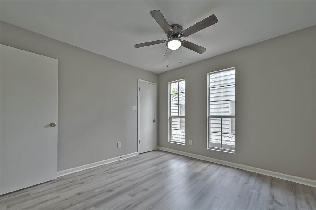 17805 Villa Way Drive Spring, TX 77379 - Photo 28 of 50 an empty room with wooden floor fan and windows