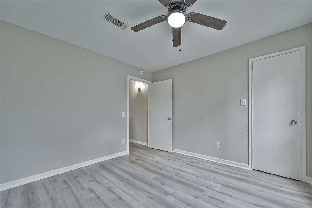 17805 Villa Way Drive Spring, TX 77379 - Photo 29 of 50 an empty room with wooden floor and ceiling fan