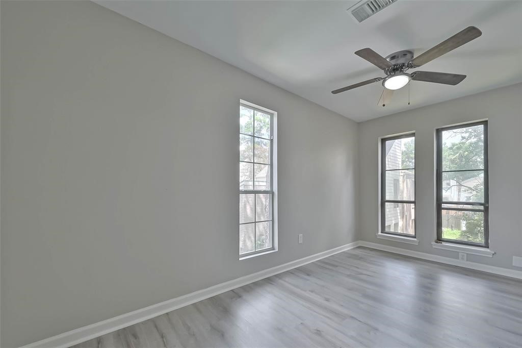 17805 Villa Way Drive Spring, TX 77379 - Photo 31 of 50 a view of an empty room with a window and wooden floor