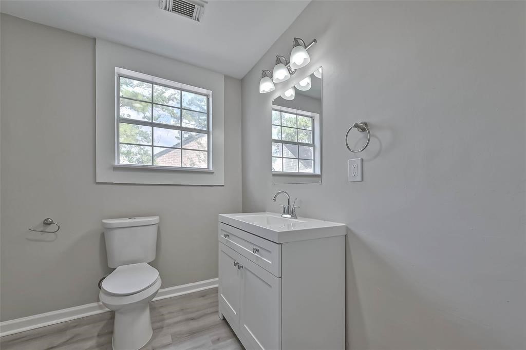 17805 Villa Way Drive Spring, TX 77379 - Photo 35 of 50 a bathroom with a toilet a sink and mirror