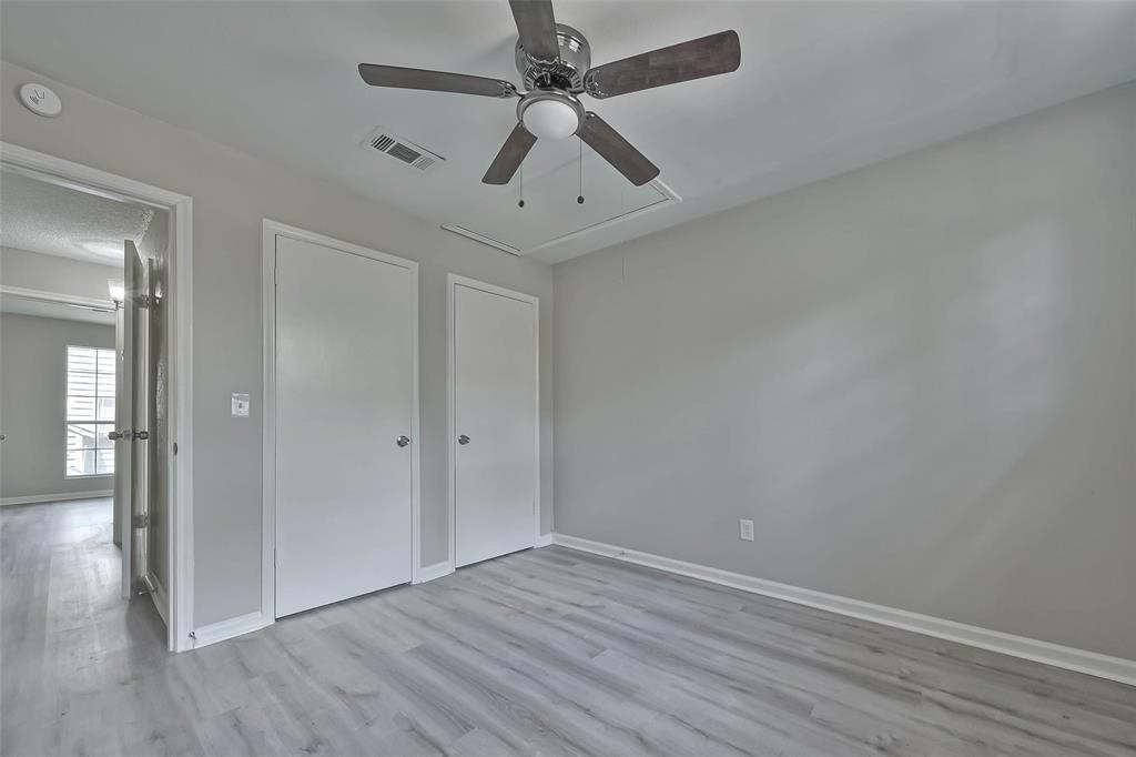 17805 Villa Way Drive Spring, TX 77379 - Photo 38 of 50 an empty room with wooden floor and windows