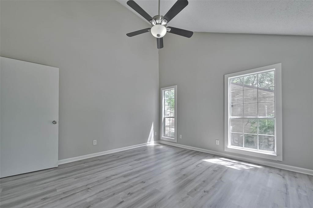 17805 Villa Way Drive Spring, TX 77379 - Photo 45 of 50 an empty room with wooden floor fan and windows