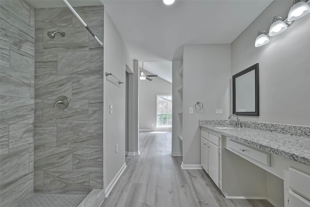 17805 Villa Way Drive Spring, TX 77379 - Photo 47 of 50 a bathroom with a granite countertop sink a mirror and a shower
