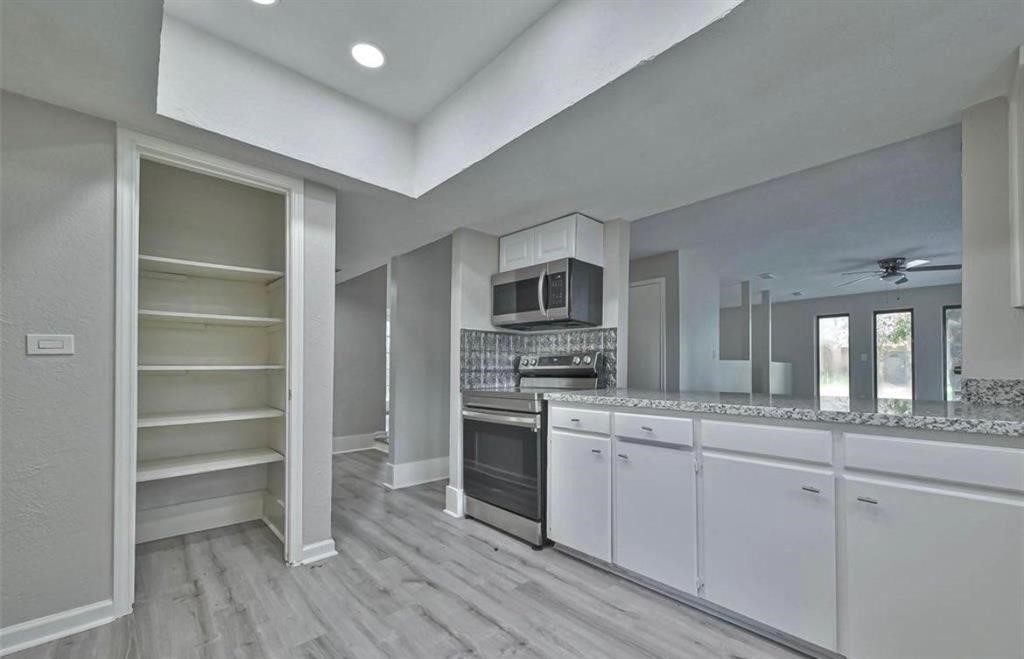 17805 Villa Way Drive Spring, TX 77379 - Photo 9 of 50 a kitchen with stainless steel appliances granite countertop a stove and cabinets