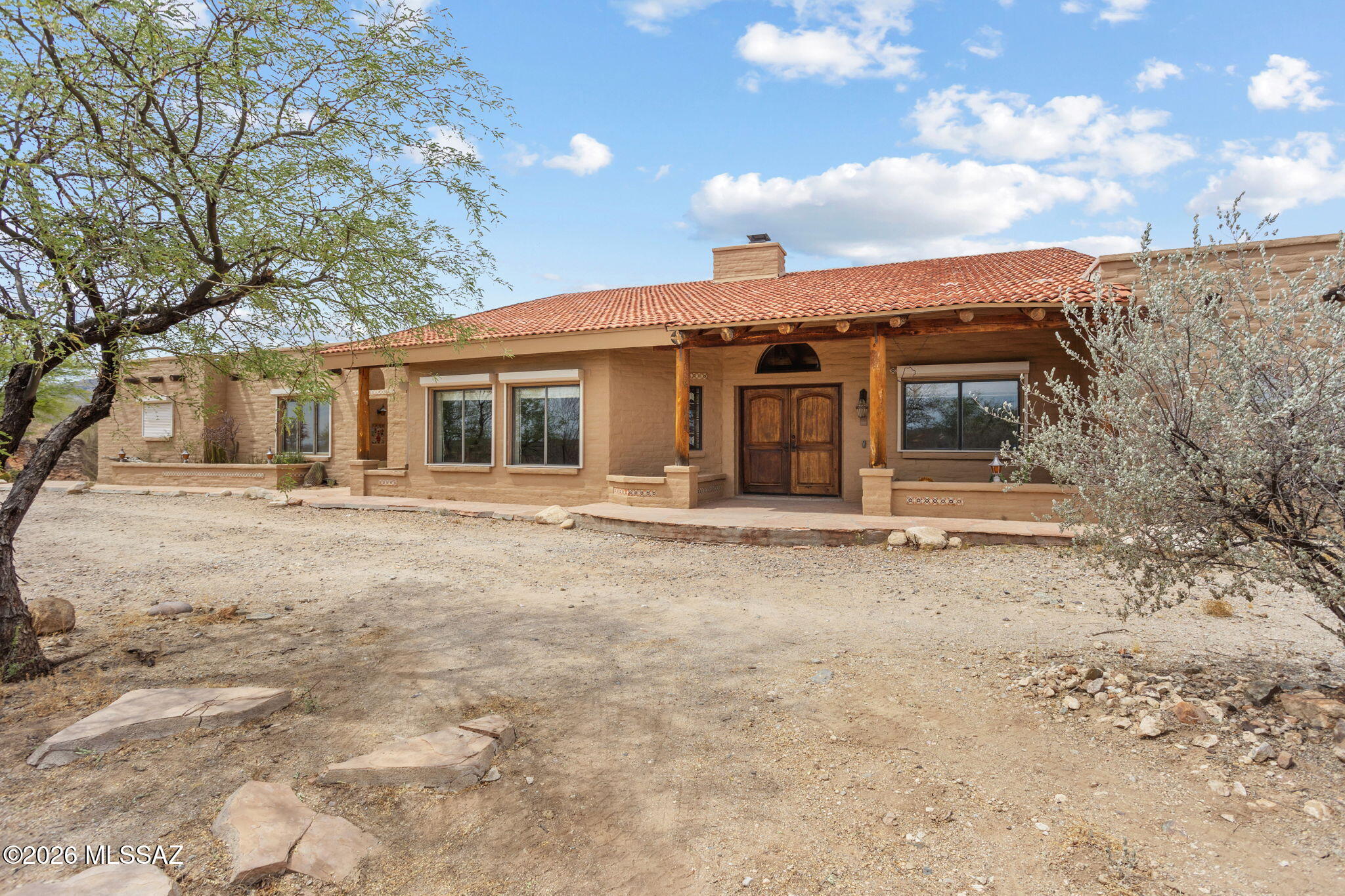 7171 South X9 Ranch Road Vail, AZ 85641 - Photo 2 of 50 Spanish tile & built-up reflective roof. 2 chimneys, exterior rolling shades. Flagstone walkway.