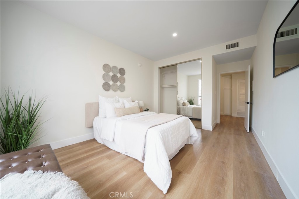 104 South Hayworth Avenue, Unit 204 Los Angeles, CA 90048 - Photo 11 of 52 a bed room with a bed and a chandelier