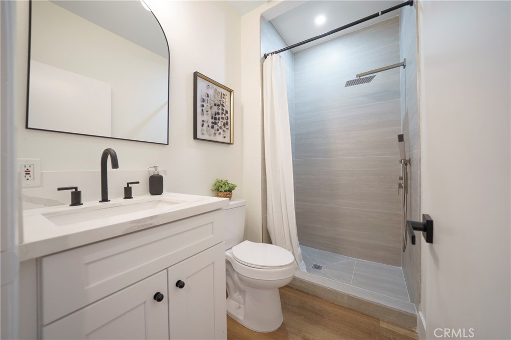104 South Hayworth Avenue, Unit 204 Los Angeles, CA 90048 - Photo 13 of 52 a bathroom with a sink a toilet and shower