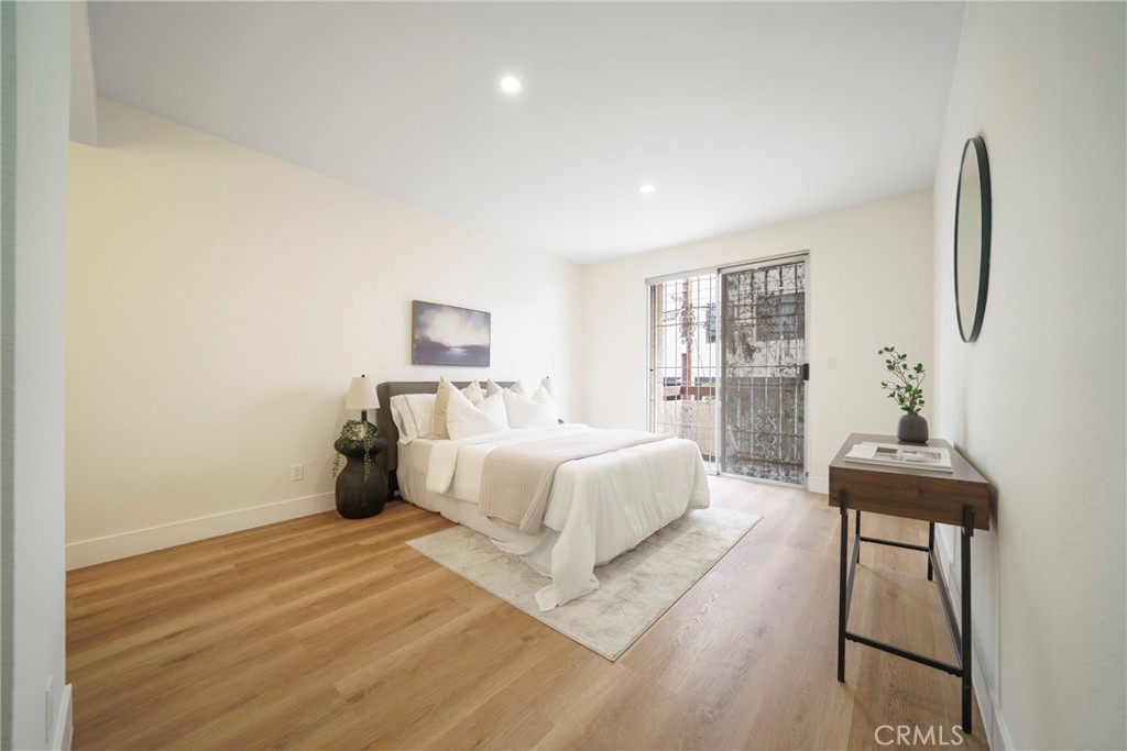 104 South Hayworth Avenue, Unit 204 Los Angeles, CA 90048 - Photo 14 of 52 a bed room with a bed and a chair