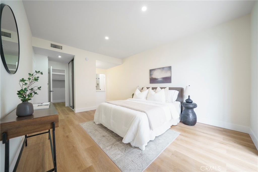 104 South Hayworth Avenue, Unit 204 Los Angeles, CA 90048 - Photo 15 of 52 a bedroom with a bed and a potted plant