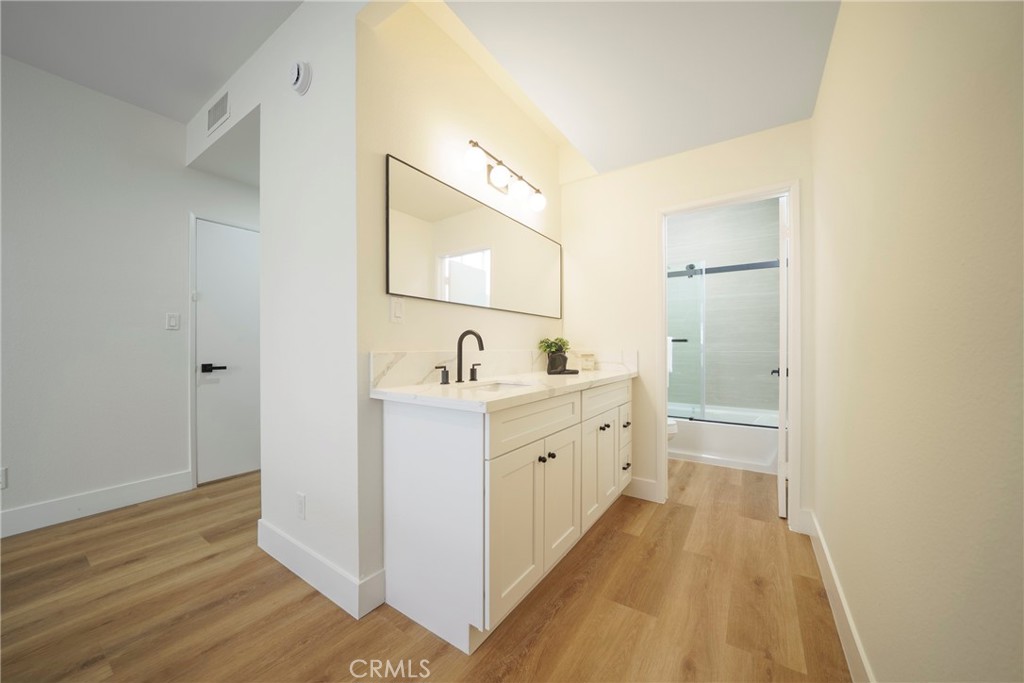 104 South Hayworth Avenue, Unit 204 Los Angeles, CA 90048 - Photo 18 of 52 a bathroom with a double vanity sink and mirror