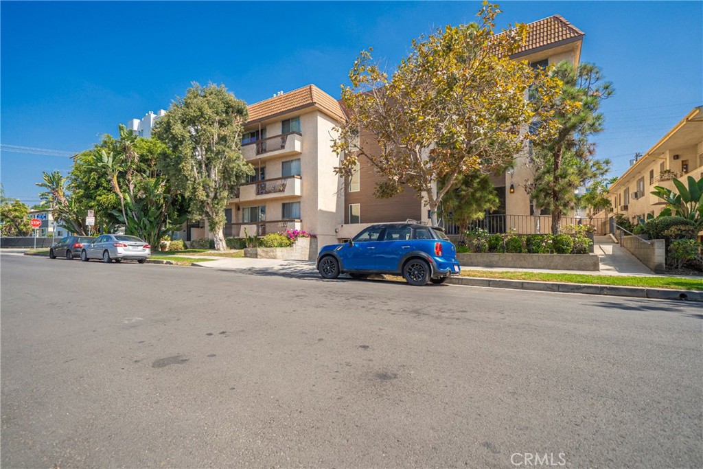 104 South Hayworth Avenue, Unit 204 Los Angeles, CA 90048 - Photo 33 of 52 a tall buildings with trees in front of it