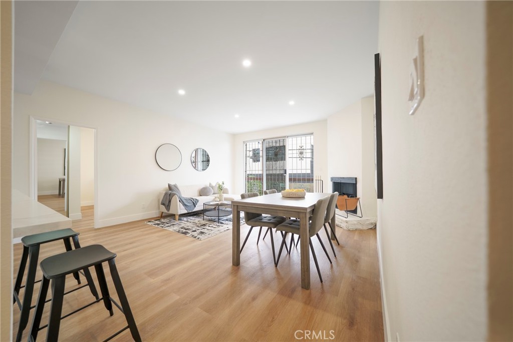 104 South Hayworth Avenue, Unit 204 Los Angeles, CA 90048 - Photo 4 of 52 a view of a dining room with furniture and wooden floor
