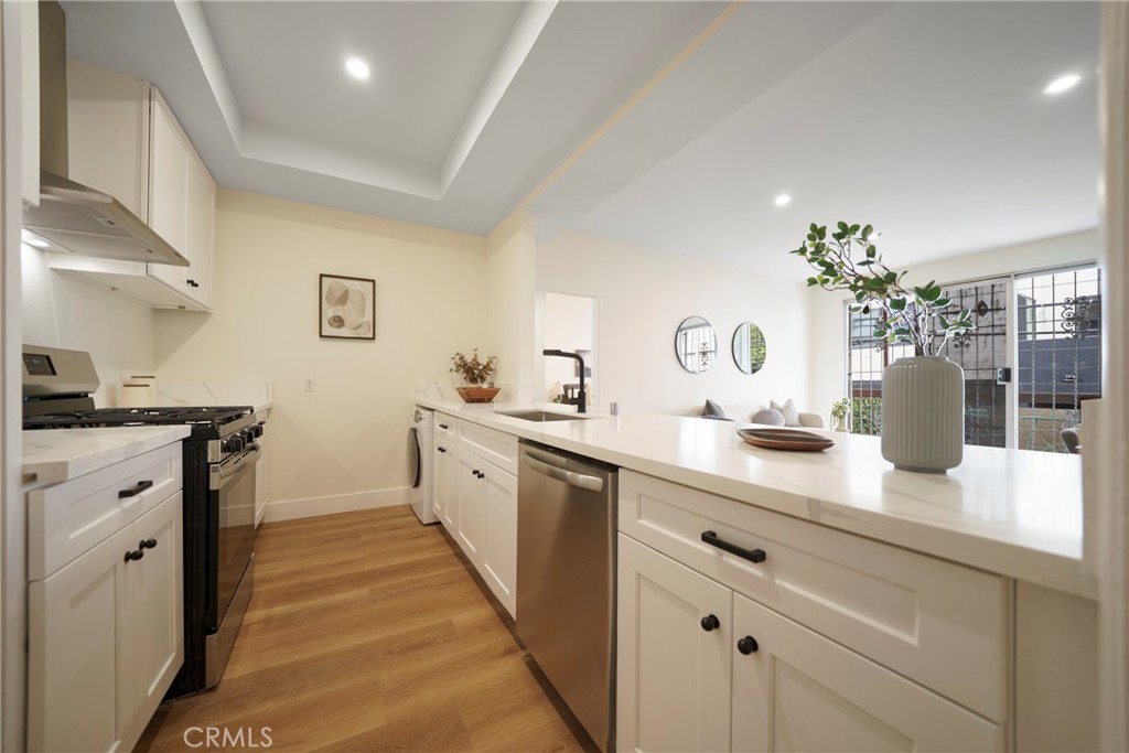 104 South Hayworth Avenue, Unit 204 Los Angeles, CA 90048 - Photo 5 of 52 a spacious bathroom with a granite countertop sink a mirror and a