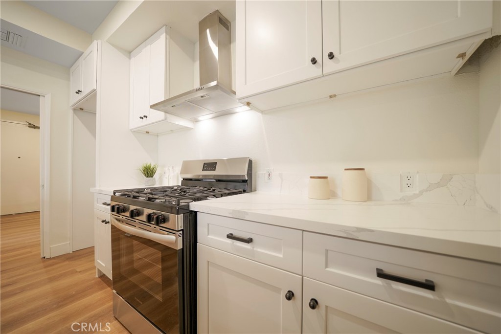 104 South Hayworth Avenue, Unit 204 Los Angeles, CA 90048 - Photo 6 of 52 a kitchen with cabinets appliances and a counter top