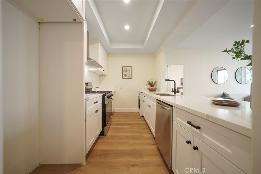 104 South Hayworth Avenue, Unit 204 Los Angeles, CA 90048 - Photo 7 of 52 a kitchen with a sink and cabinets