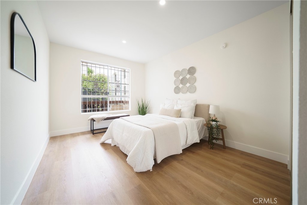 104 South Hayworth Avenue, Unit 204 Los Angeles, CA 90048 - Photo 10 of 52 a bedroom with a bed and a window