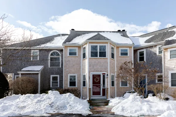a front view of a house with a yard and seating space