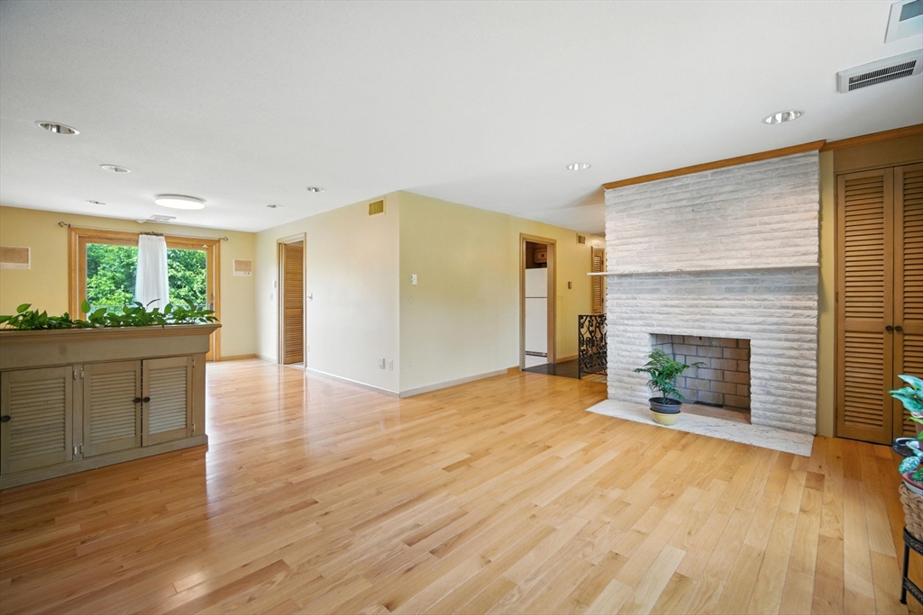 22 Woodland Road Springfield, MA 01129 - Photo 14 of 36 an empty room with kitchen and fireplace