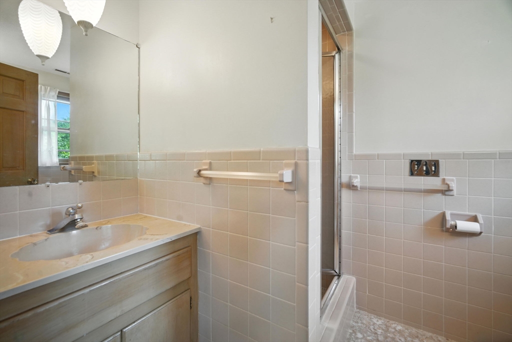 22 Woodland Road Springfield, MA 01129 - Photo 24 of 36 a bathroom with a sink and a mirror