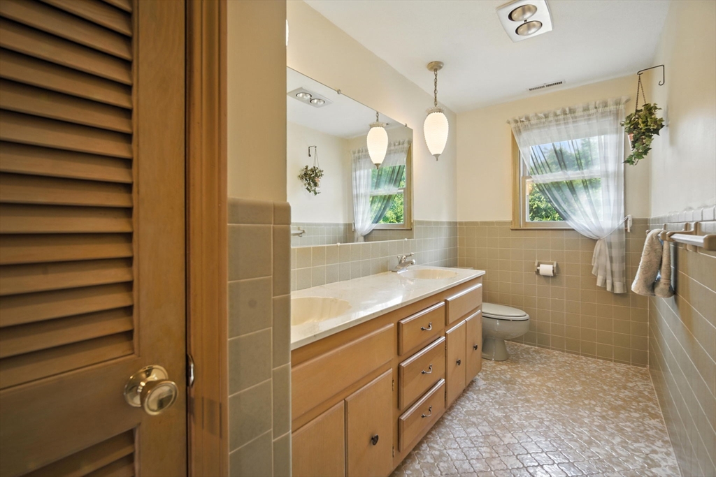 22 Woodland Road Springfield, MA 01129 - Photo 25 of 36 a bathroom with a granite countertop sink a toilet and shower