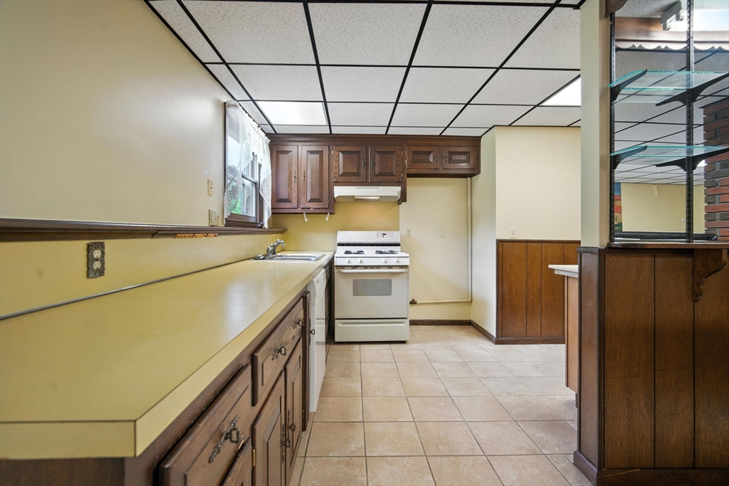 22 Woodland Road Springfield, MA 01129 - Photo 29 of 36 a kitchen with a stove a refrigerator and a sink
