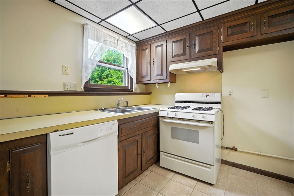 22 Woodland Road Springfield, MA 01129 - Photo 30 of 36 a kitchen with a sink cabinets stainless steel appliances and a window
